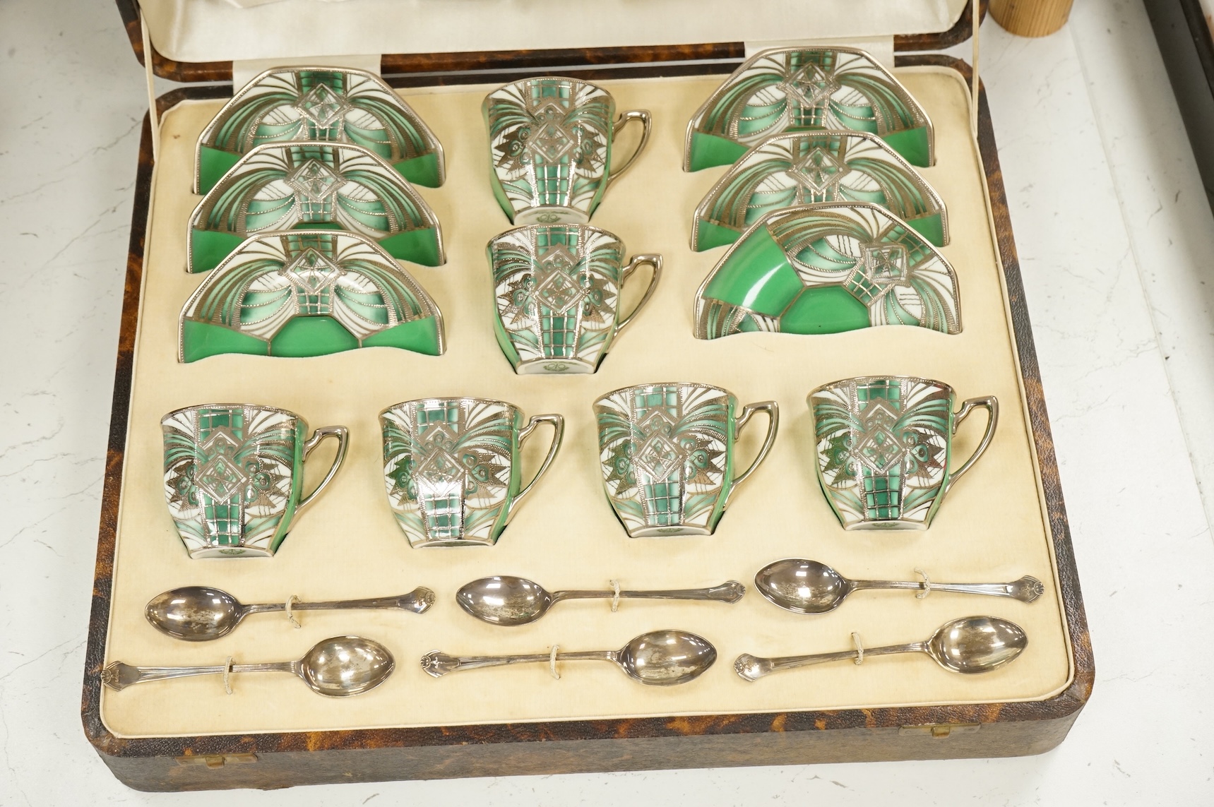 A Noritake coffee set, six-place setting including silver spoons, Sheffield 1932